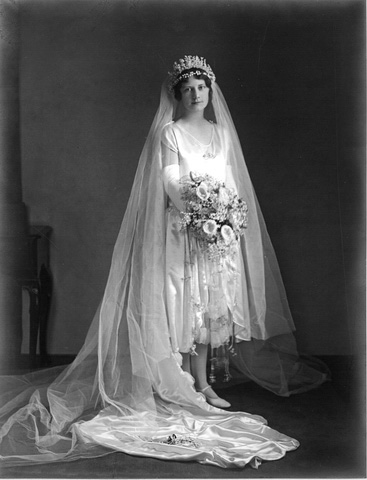 Portrait of bride dressed in white wedding gown.