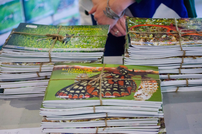 Stacks of Toronto Biodiversity books sit on a table bound with twine