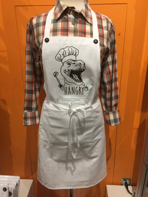 Photo of an apron featuring a picture of a dinosaur