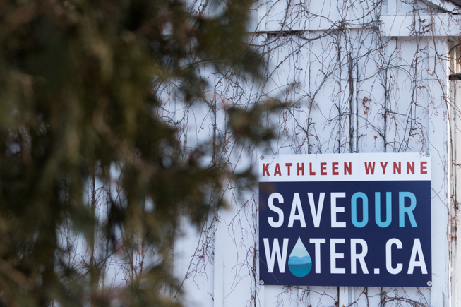 A sign reads "Kathleen Wynne SAVEOURWATER.CA"
