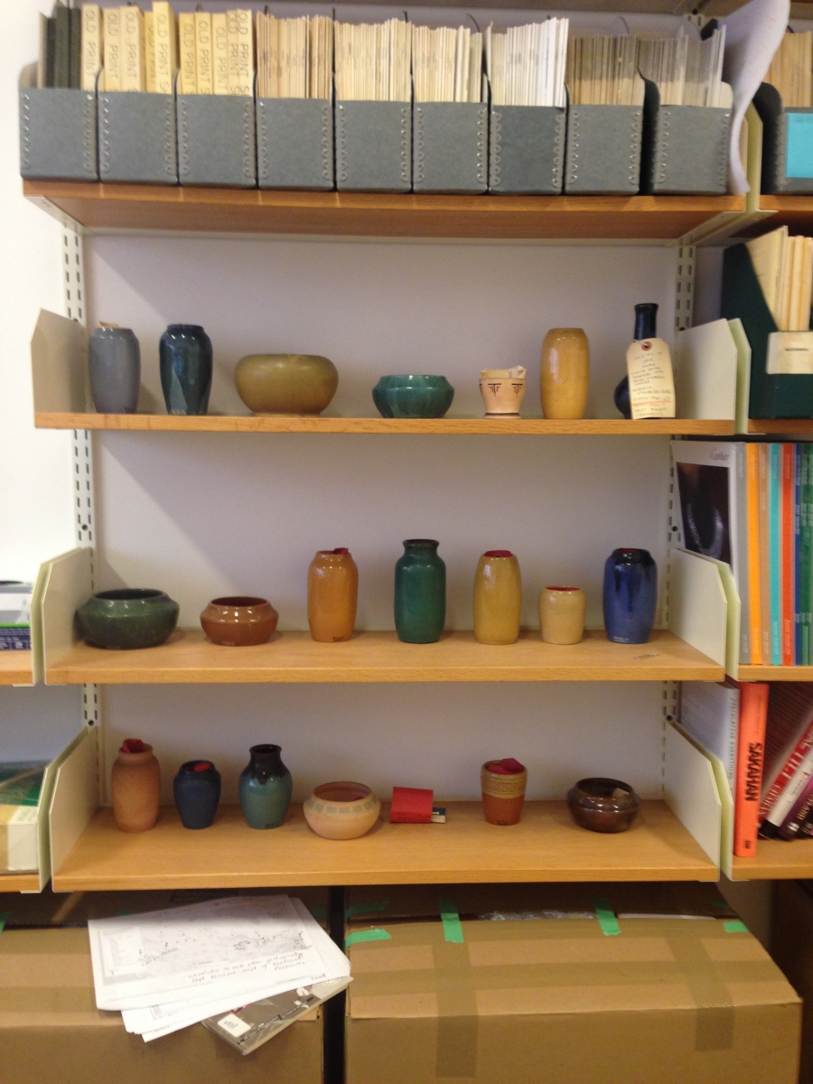 collection of ceramic vessels on a shelf