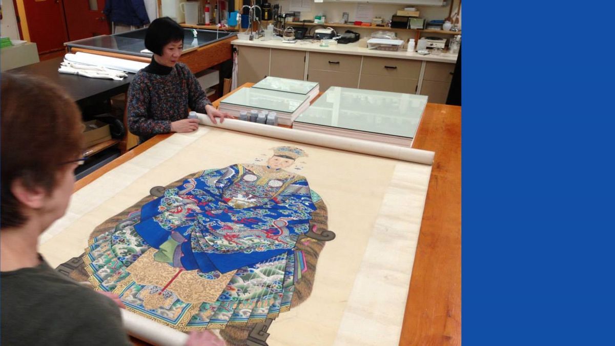 ROM staff examining a portrait