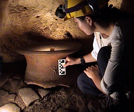 Kay takes a closer look at small decoration on the artifact.