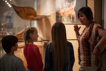 a teacher instructs children in the first peoples' gallery