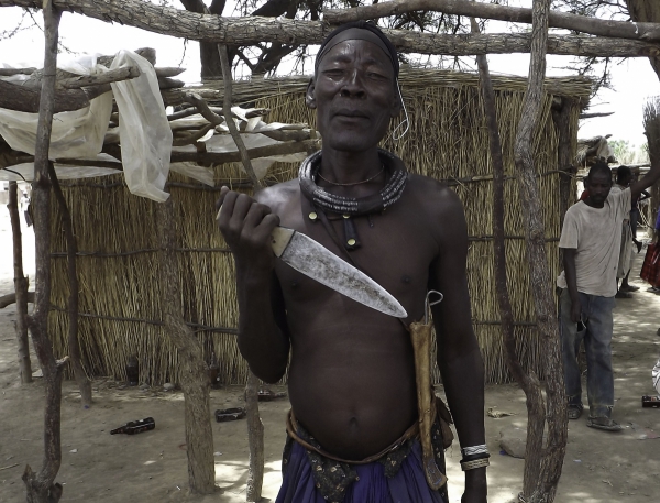Himba man showing his knife 