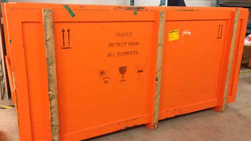 Crate with message "Fragile. Protect from all elements" and other shipping icons.