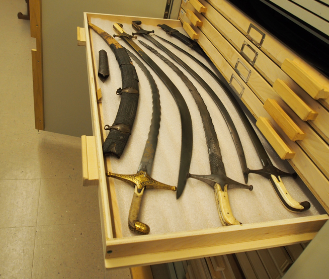 A drawer filled to overflowing with Persian swords, most of which were acquired in India by Lord Kitchener.