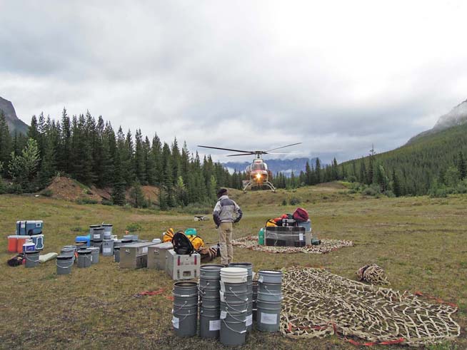 Sorting out field gear in nets at the field helipad (image courtesy of Gabriela Mangano)