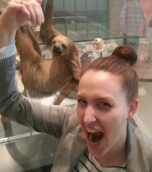 Woman posing with sloth in the Gallery of Mammals on Level 2.