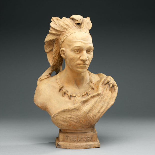 Terracotta bust on grey background.