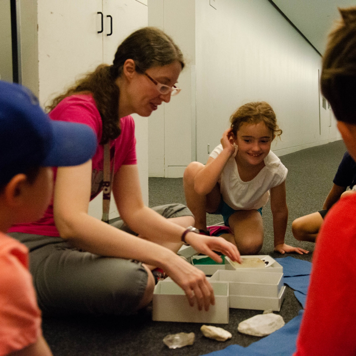 Bethany and her class look at hands on specimens from the Rocks and Minerals collections. Image: Michael Berger