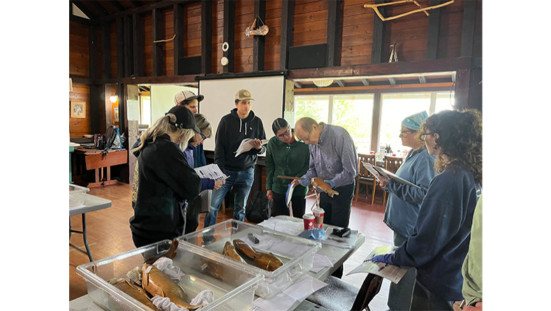 Group of people in the workshop gathered around table