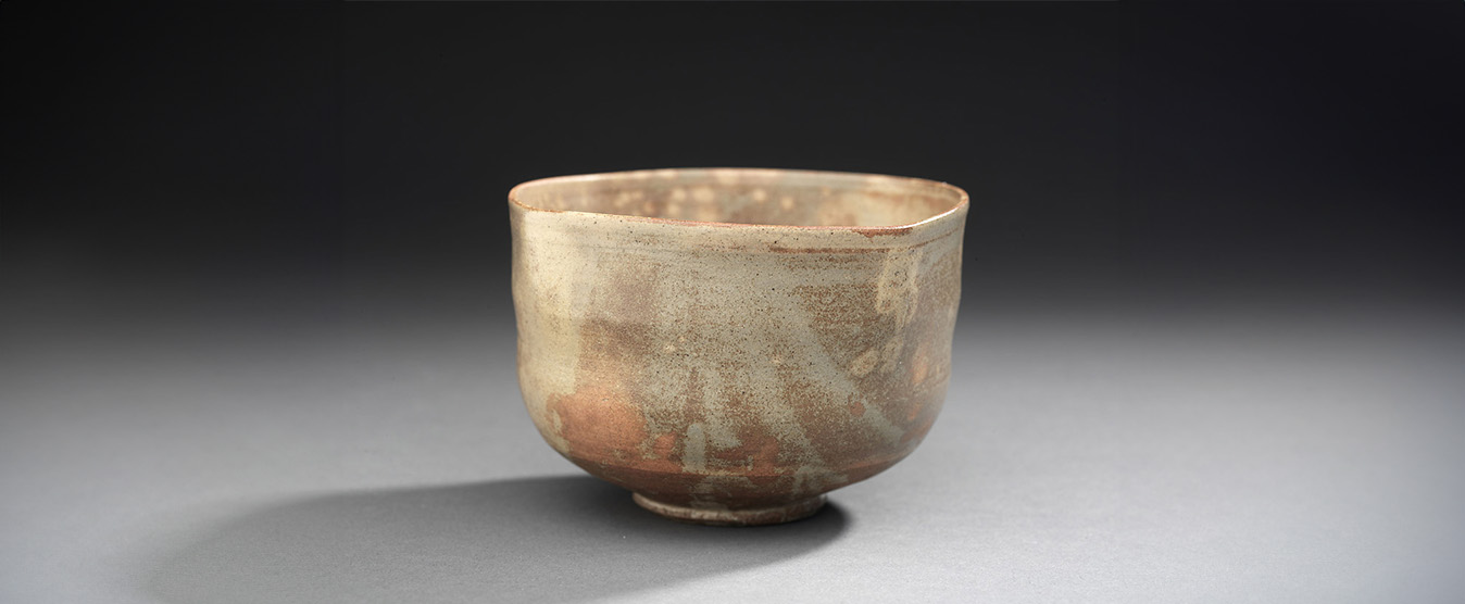 A small vase featuring a rich brown glaze, showcasing a smooth and elegant surface.