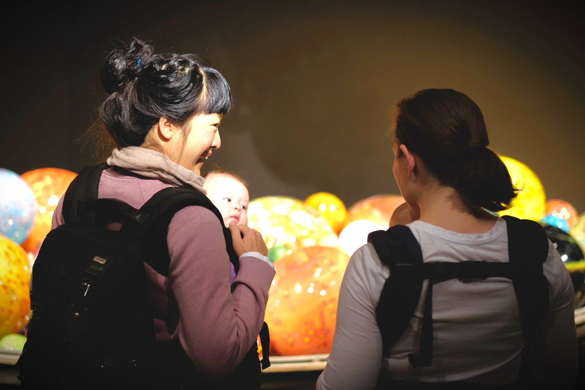 Two mothers carry with their baby in a carrier bag at ROM 