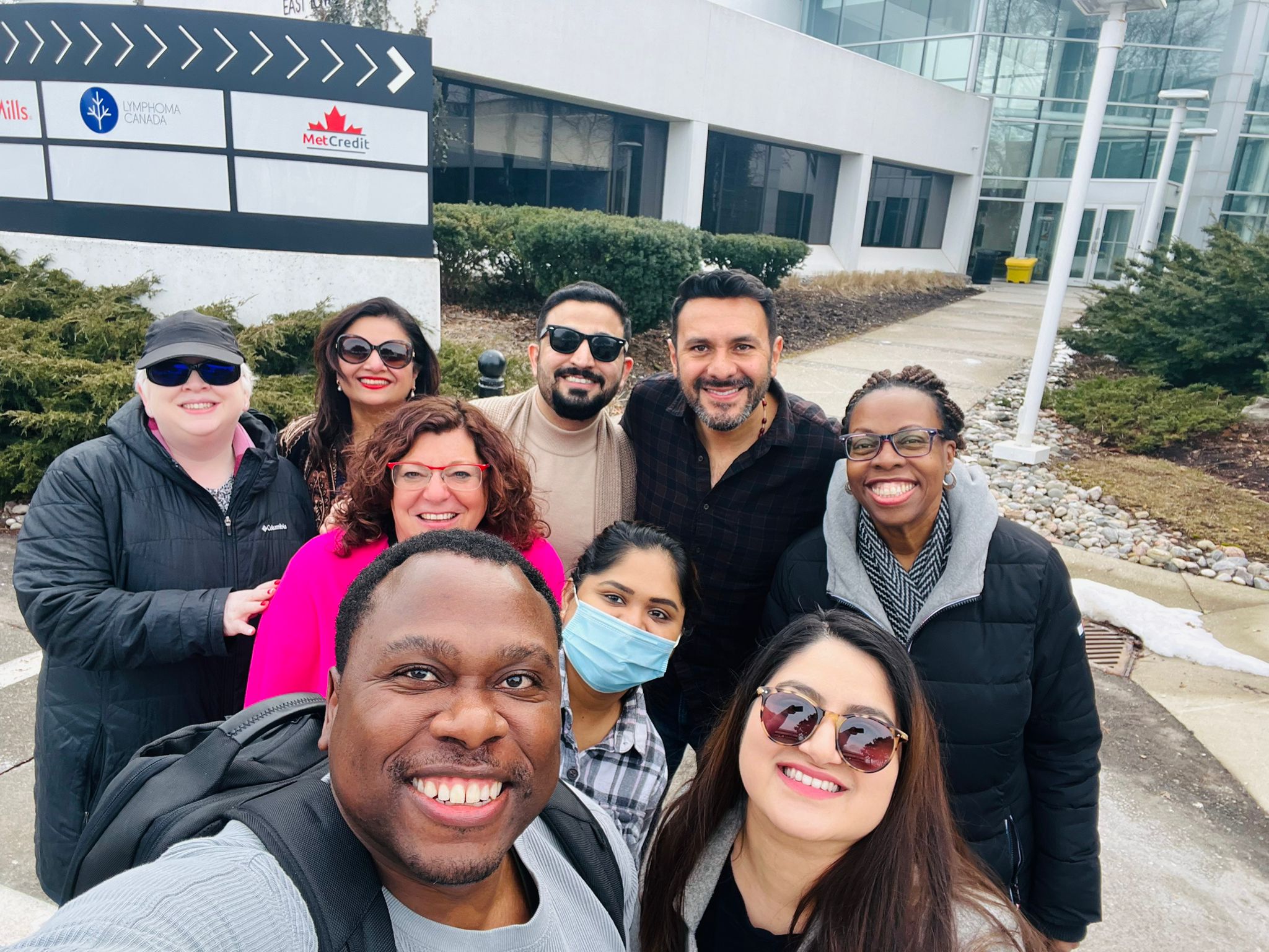 A group of diverse people taking a picture for the camera.