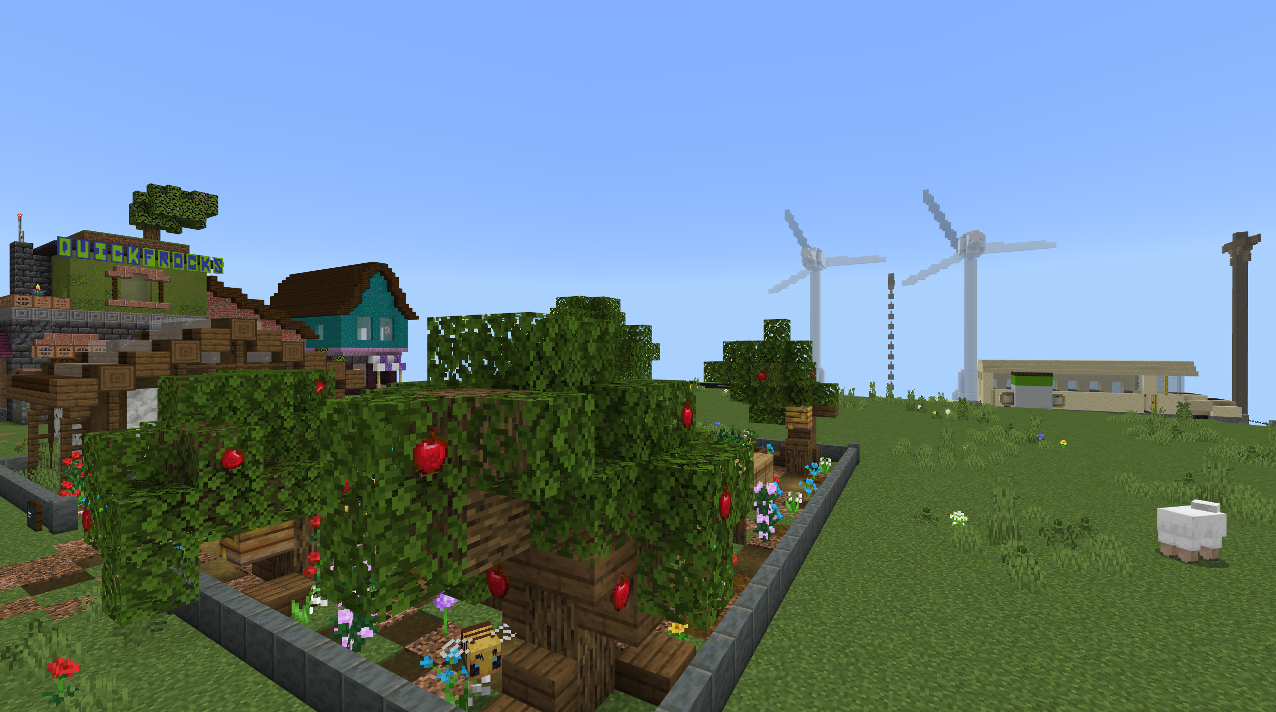 A minecraft screenshot of a community garden with trees and crops, showing windmills and an electric bus in the background.