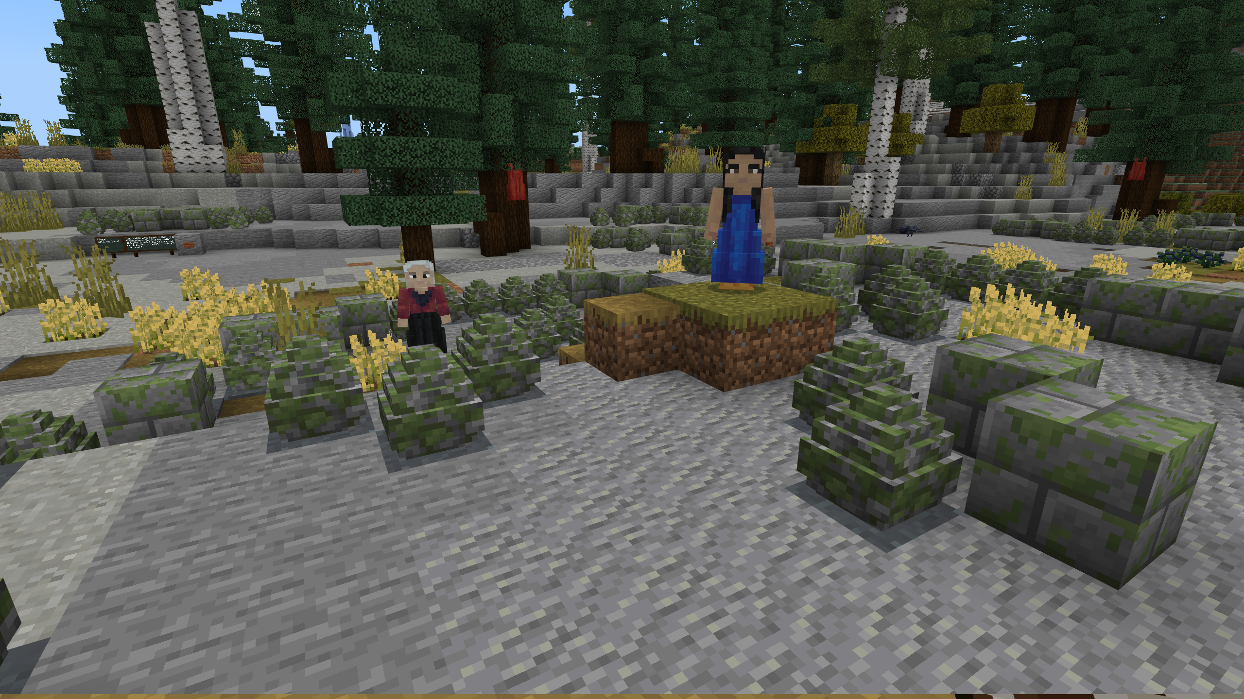 A Minecraft screenshot of an Indigenous woman in a blue dress with dark hair, and an Indigenous woman in a red dress with white hair, standing in amongst rock formations.