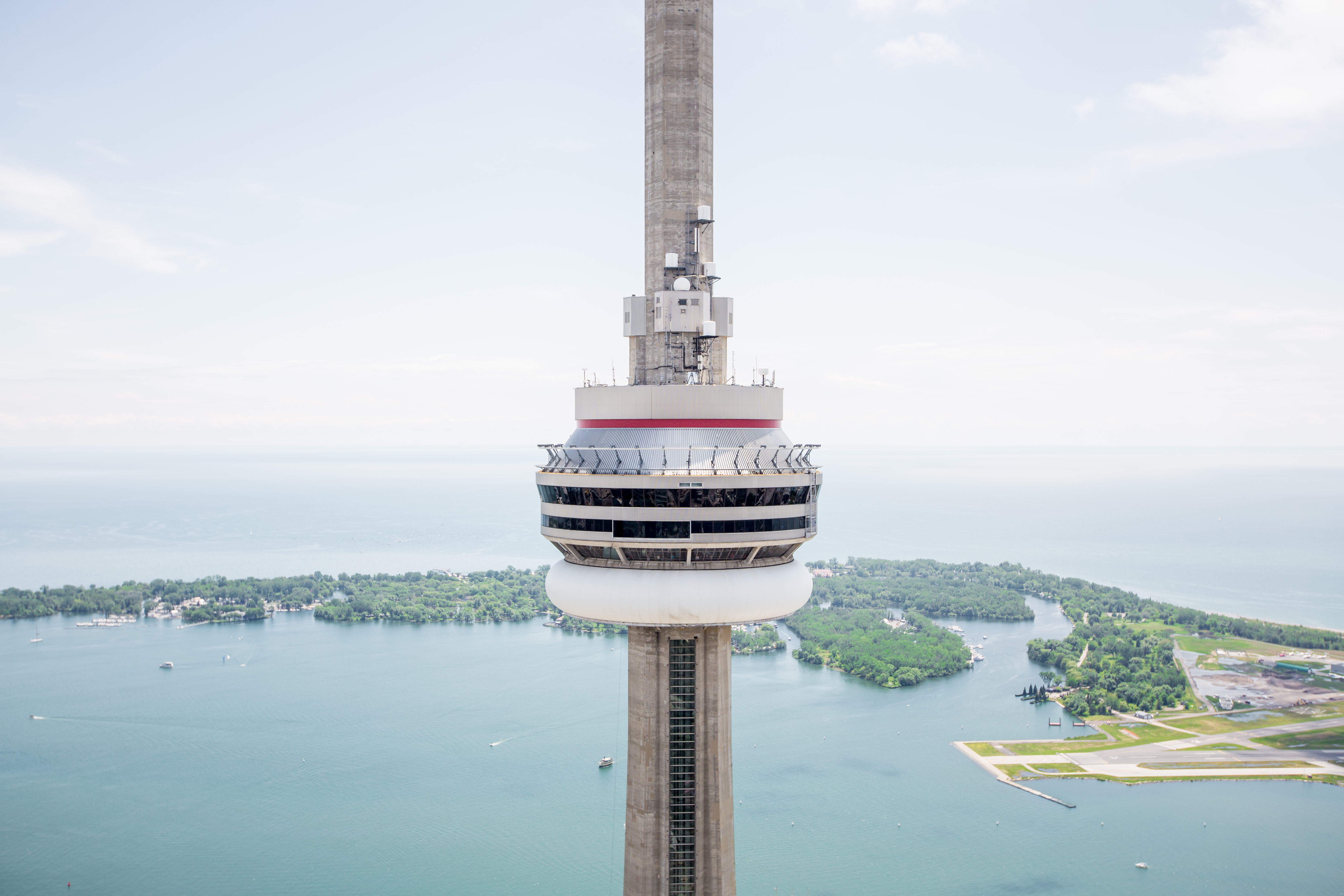 View of the top of the CN Tower with Lake Ontario and the city in the background