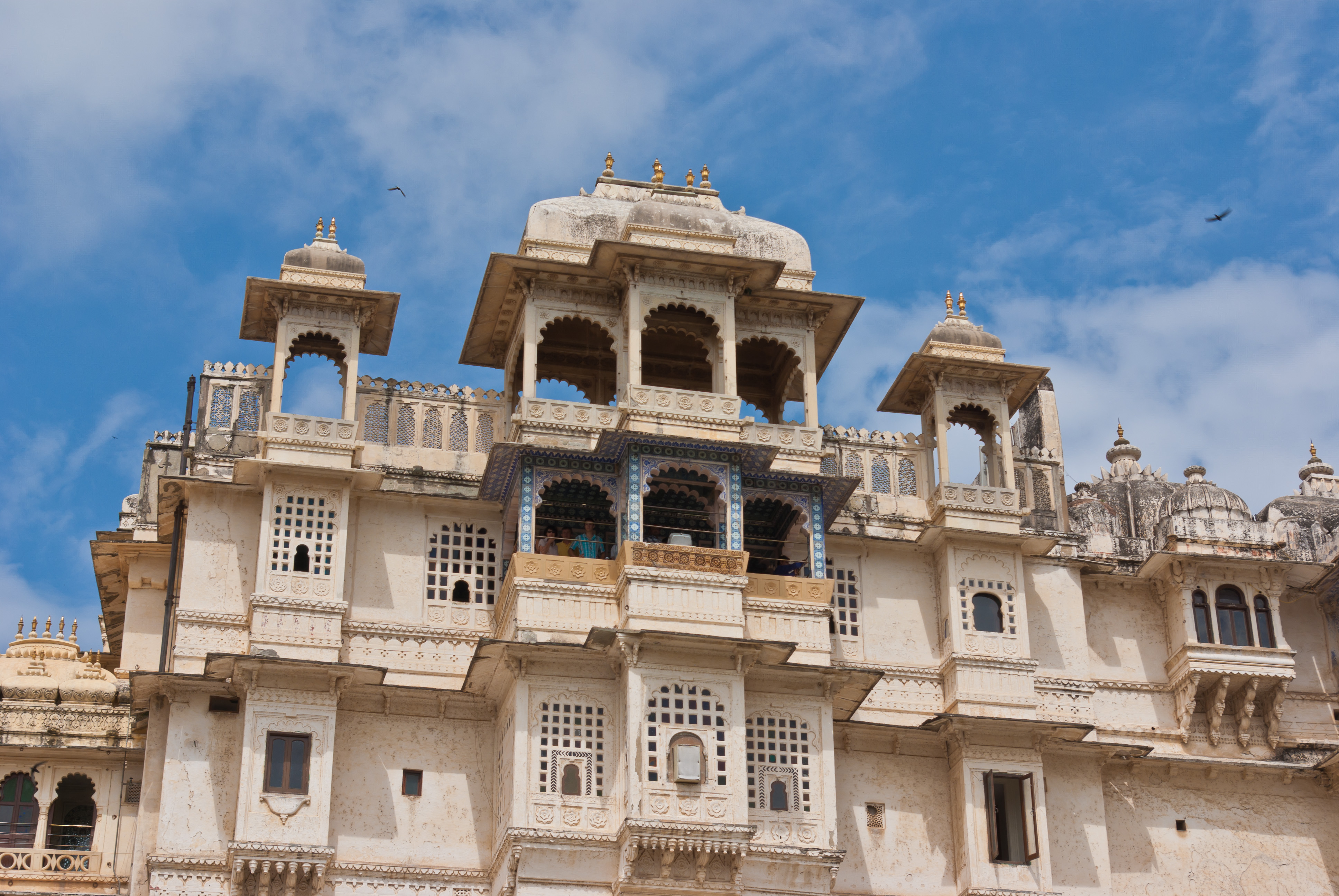 A white building with many windows against a blue sky