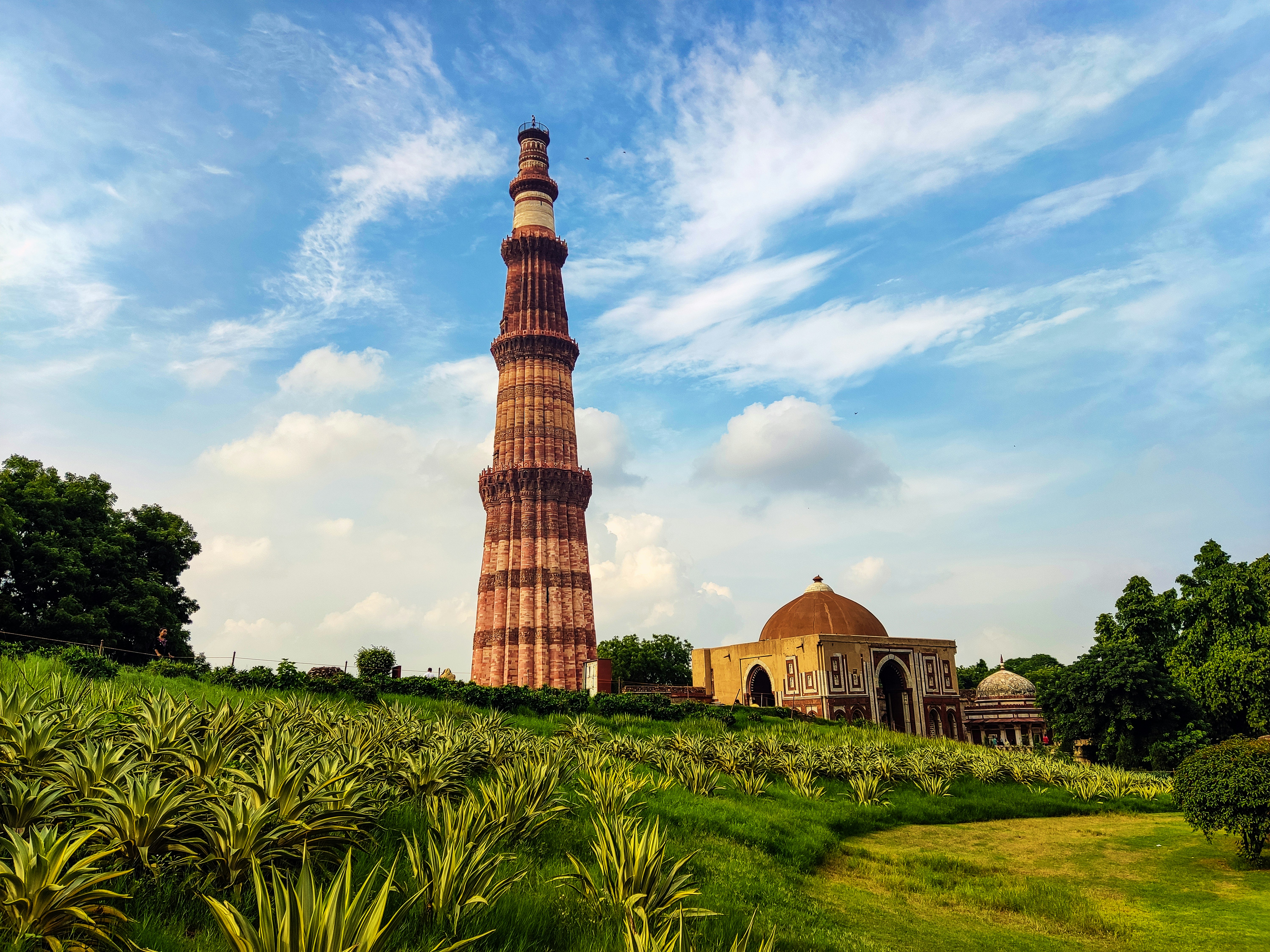 A group of people walking in front of a tower.