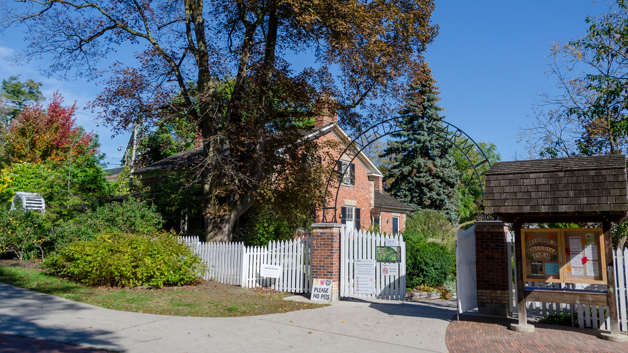 Entrance to Riverdale farm with gate in foreground and building in backgroun