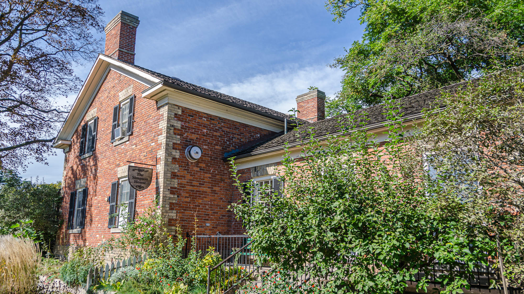 Front view of building on left with garden on the right