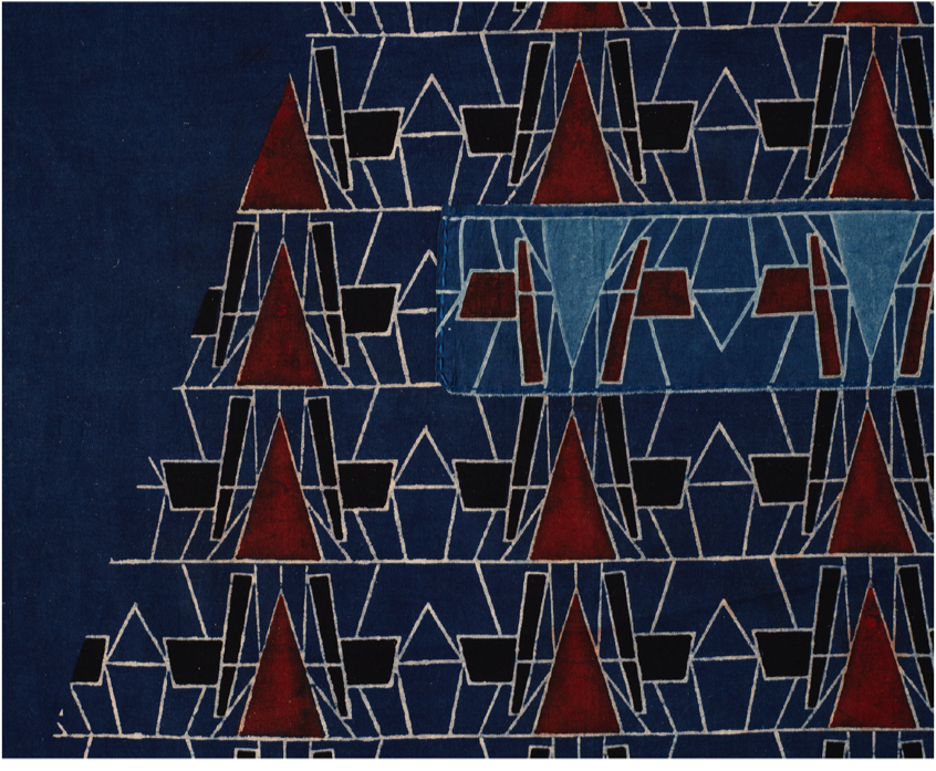 Motif géométrique bleu foncé avec triangles rouges et lignes blanches formant un motif répétitif abstrait.