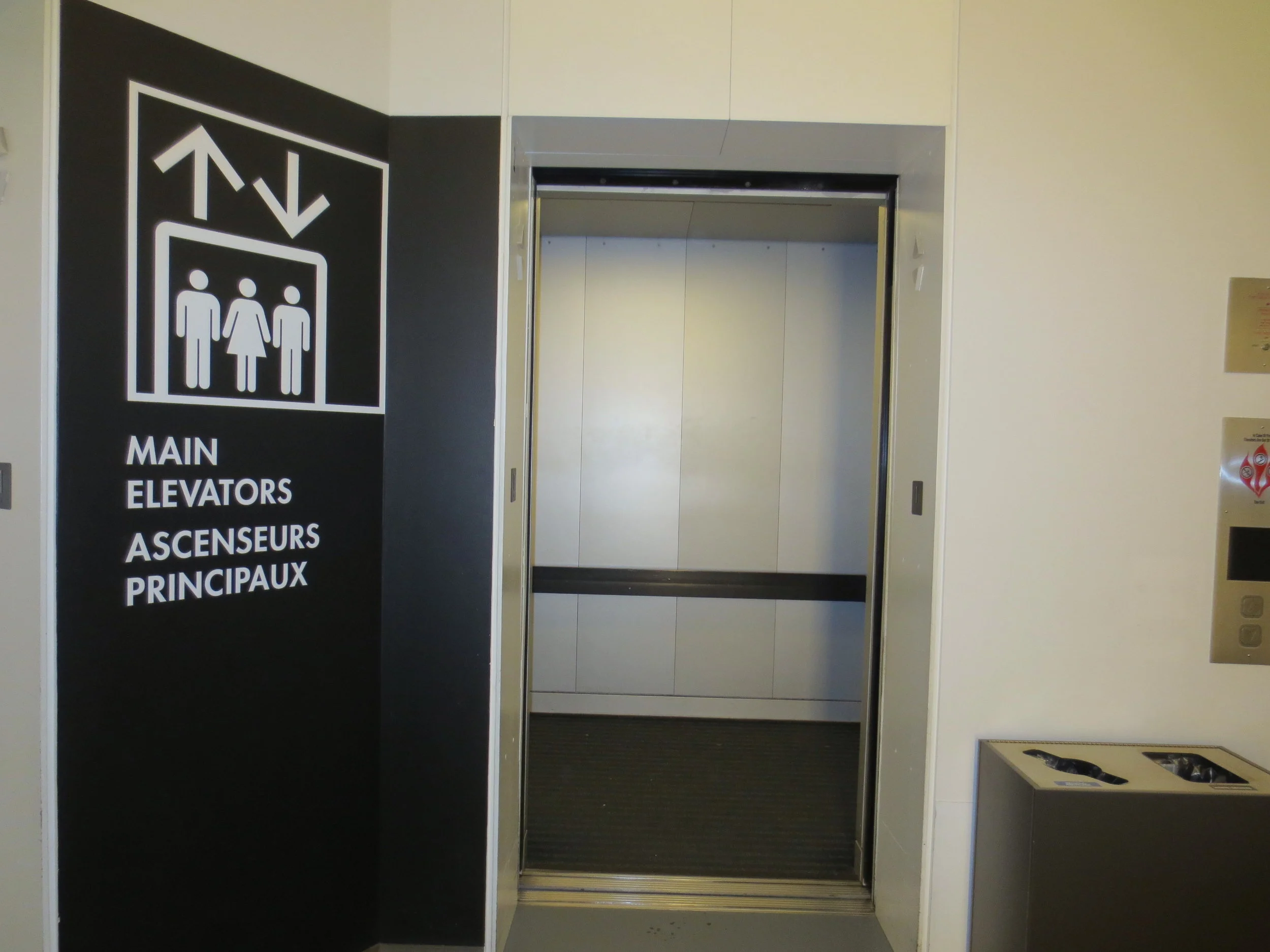 Elevator sign next to open elevator
