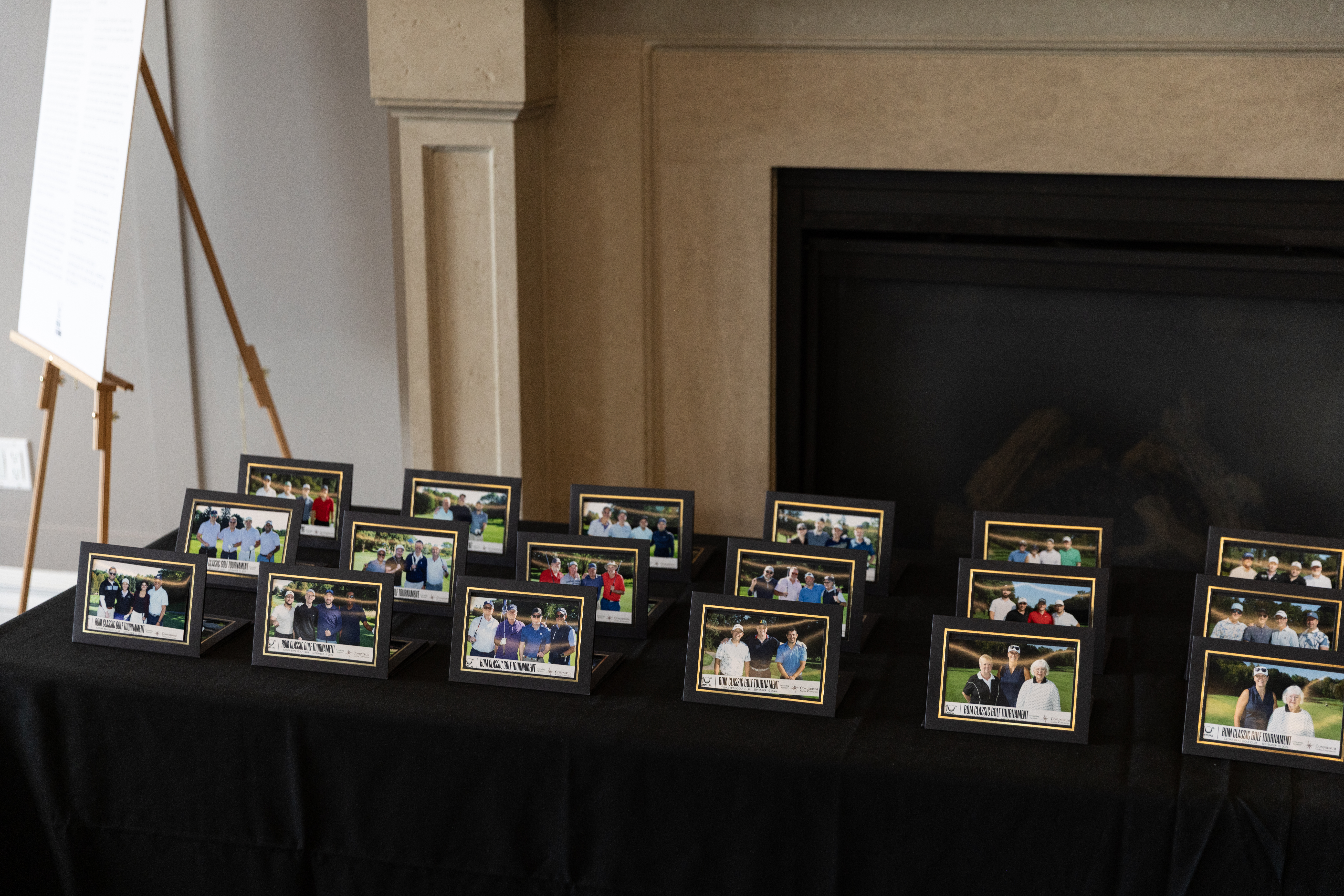 Foursome photos laid out on a table from the 10th Annual Classic Golf Tournament
