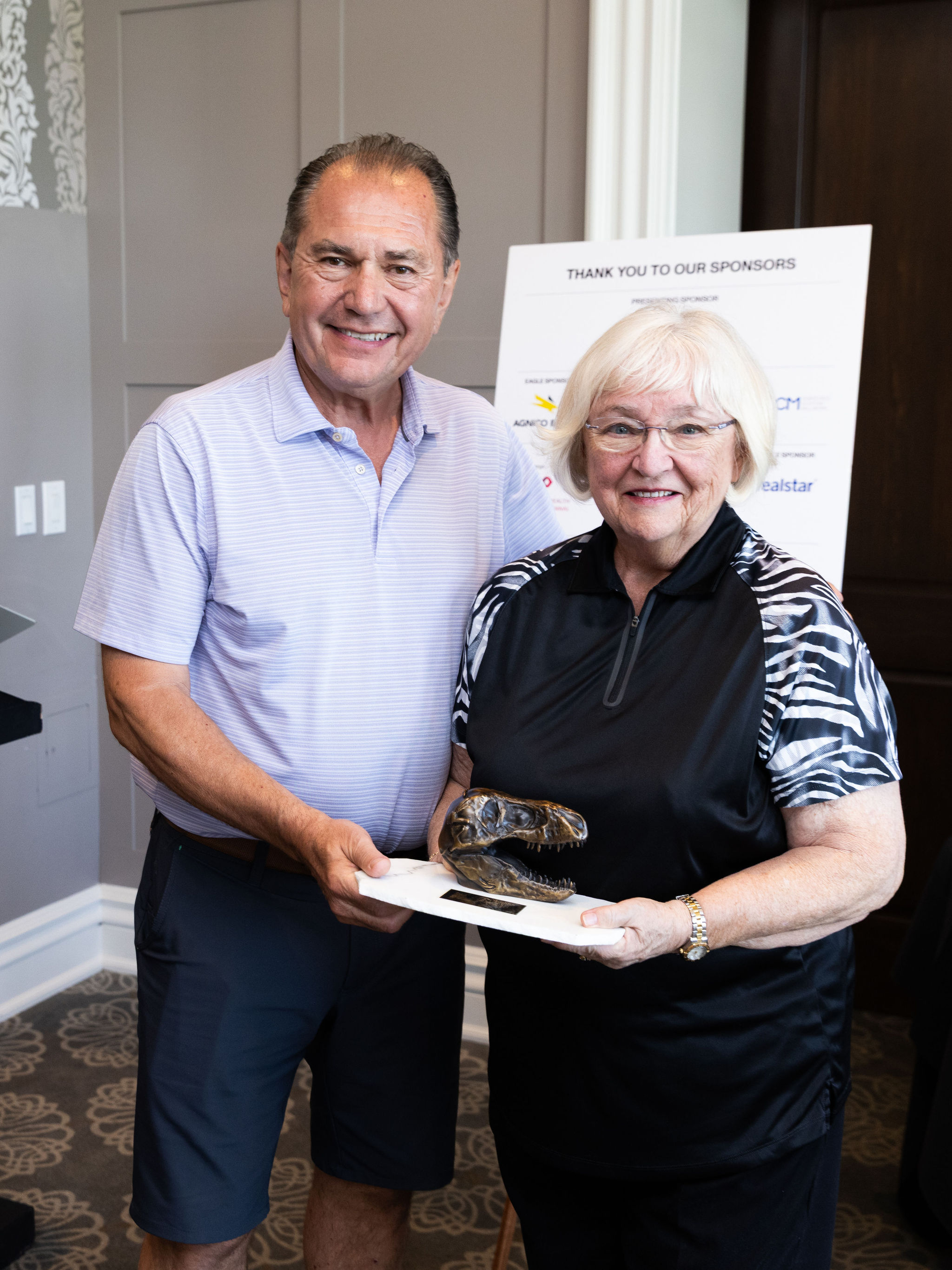 Nita Reed 10th Annual Driving Impact Award recipient and Dan Argrios in a photo together. 