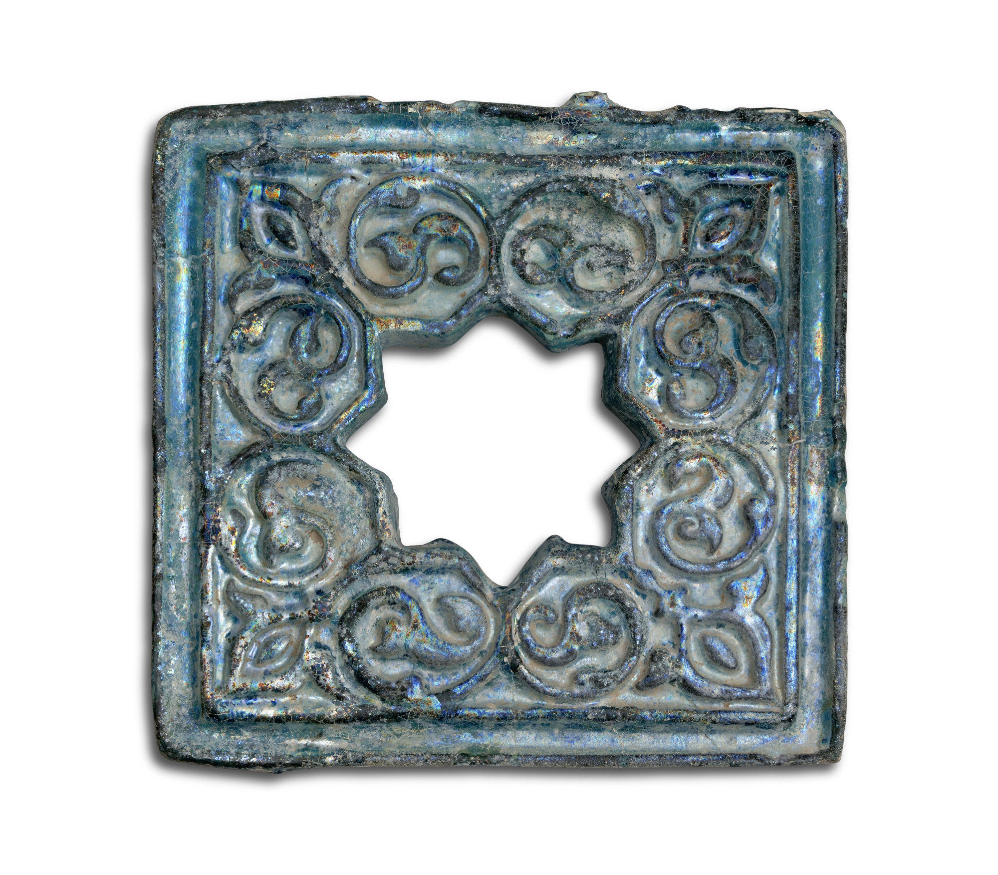 A tile featuring an open eight-pointed star in the centre surrounded by scrollwork resembling palms.