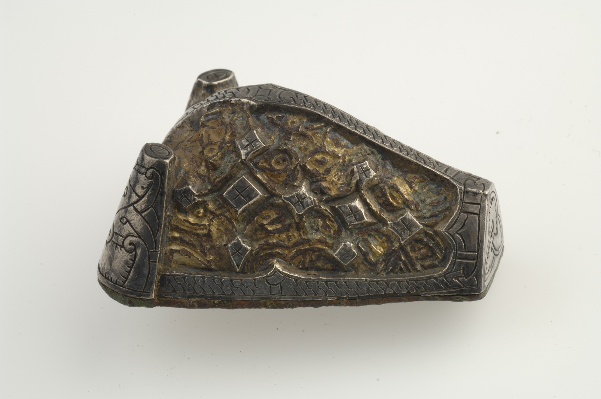Brooch, animal-head shaped. Bronze, silver and gold. Worn in pairs on the chest of women’s clothing. Distinctive to Gotland. Grave find, Hemse, Annexhemman, Gotland, Sweden. SHM 4645. Brooch, animal-head shaped, bronze, silver and gold.