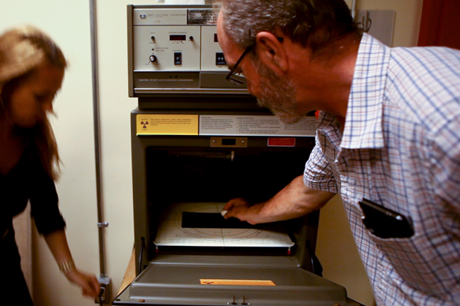 Senior conservator Heidi Sobol and Natural History technician Brad Millen place the egg in the x-ray machine.