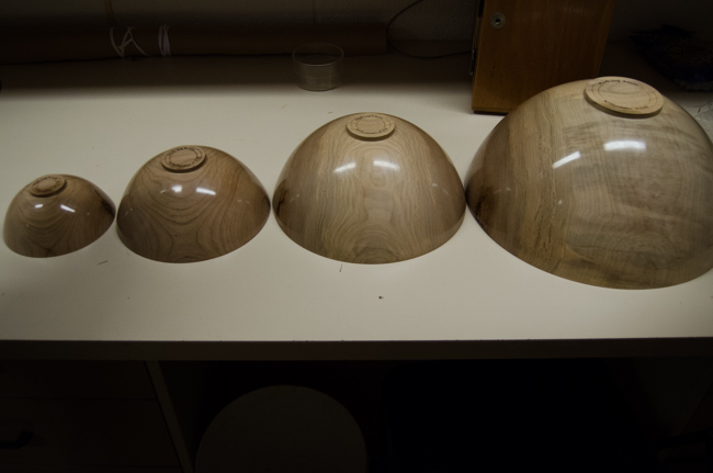 The finished set of nesting bowls unpacked and aligned on a table at the ROM. Photo by Justine DiCesare 