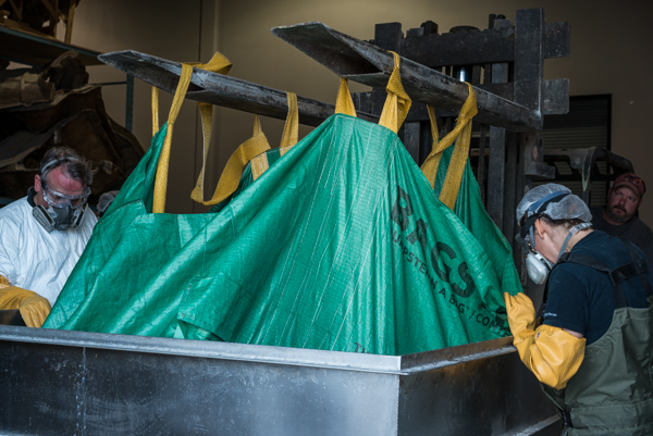 The heart is lifted by forklift out of its container to be wrapped in layers of void-wrap and plastic sheeting for its trip to Germany. Photo by Stacey Lee Kerr