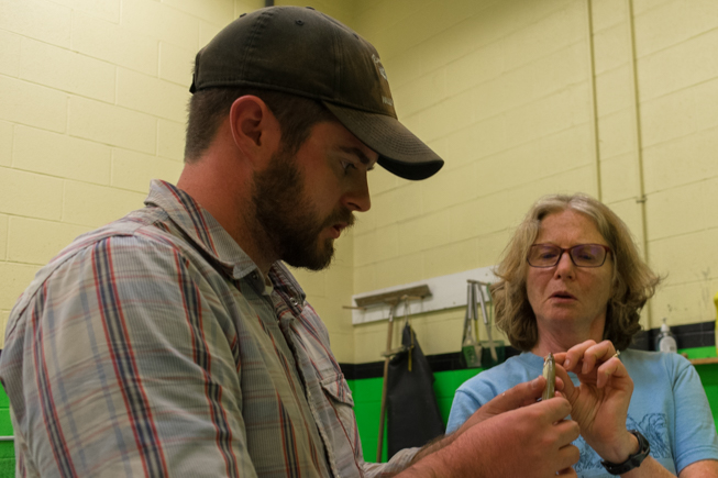 Tom Morgan, Graduate Student in Ecology and Evolutionary Biology with UofT discusses a fish identification with Margaret Zur, Ichthyology Technician