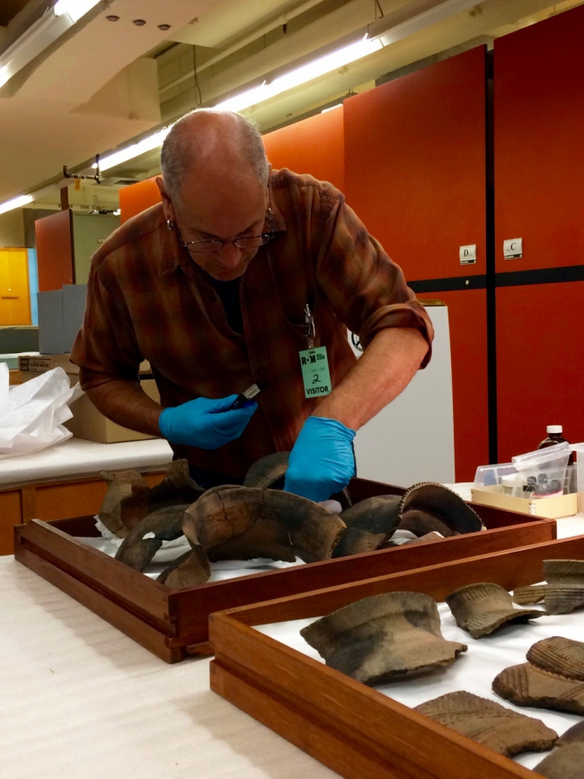 Richard Zane Smith handling the ROM's 17th-century ceramics.