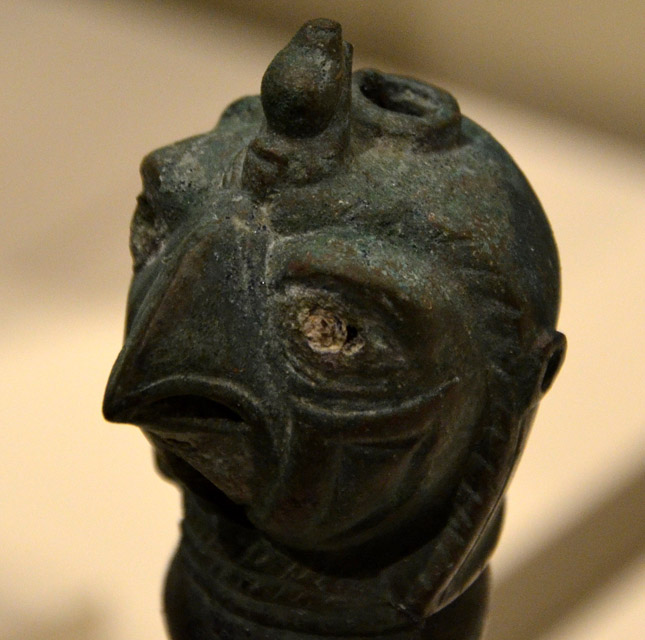 Detail of the falcon's head showing crown and the hole where the tang of the sword was peened over (image by Kay Sunahara).