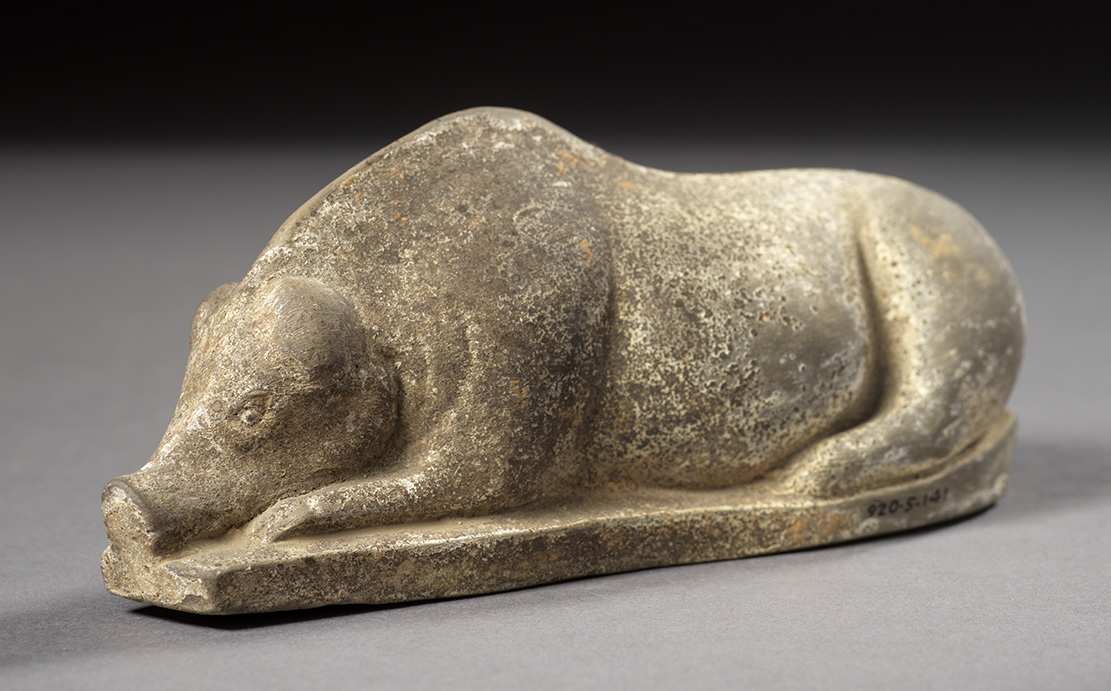 Figurine grise représentant un cochon couché