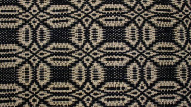 Detail of black and white woven coverlet.