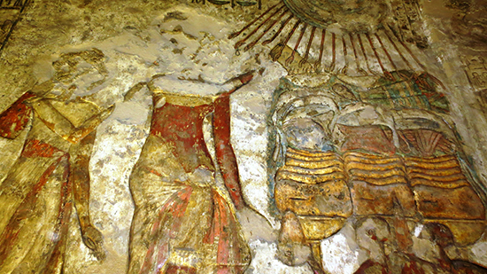 Wall relief with paint.  Gold, brown, red and blue details appear in the painting.