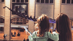 Mom and daughter admiring dinosaur skeleton