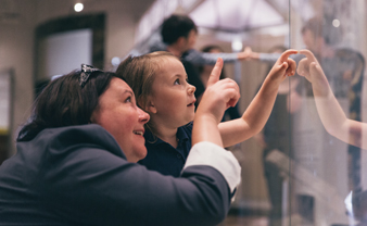 Visitors looking at a display in one of the ROM's galleries