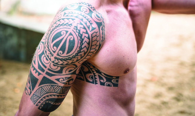 Tattoo on an arm with a geometric tribal design