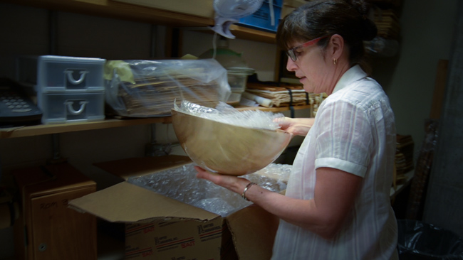Assistant Curator of Botany, Deb Metsger, unpacks the donated set of nesting bowls. Photo by Justine DiCesare
