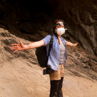 Deirdre Leowinata all suited up and ready to enter one of the many caves to take photos of bats. The face mask was necessary because the dust from bat guano can be hazardous if inhaled.