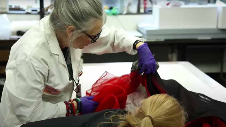 Unboxing a Dior dress in the textiles lab at the ROM.