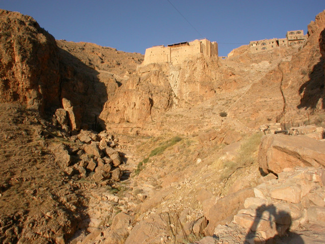View of Deir Mar Musa in 2004 from the main approach in the East, with the old buildings at the centre, and to the right the new buildings created using traditional materials and techniques.