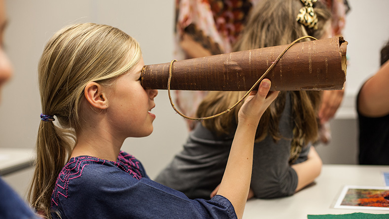 Girl looking through a telescope