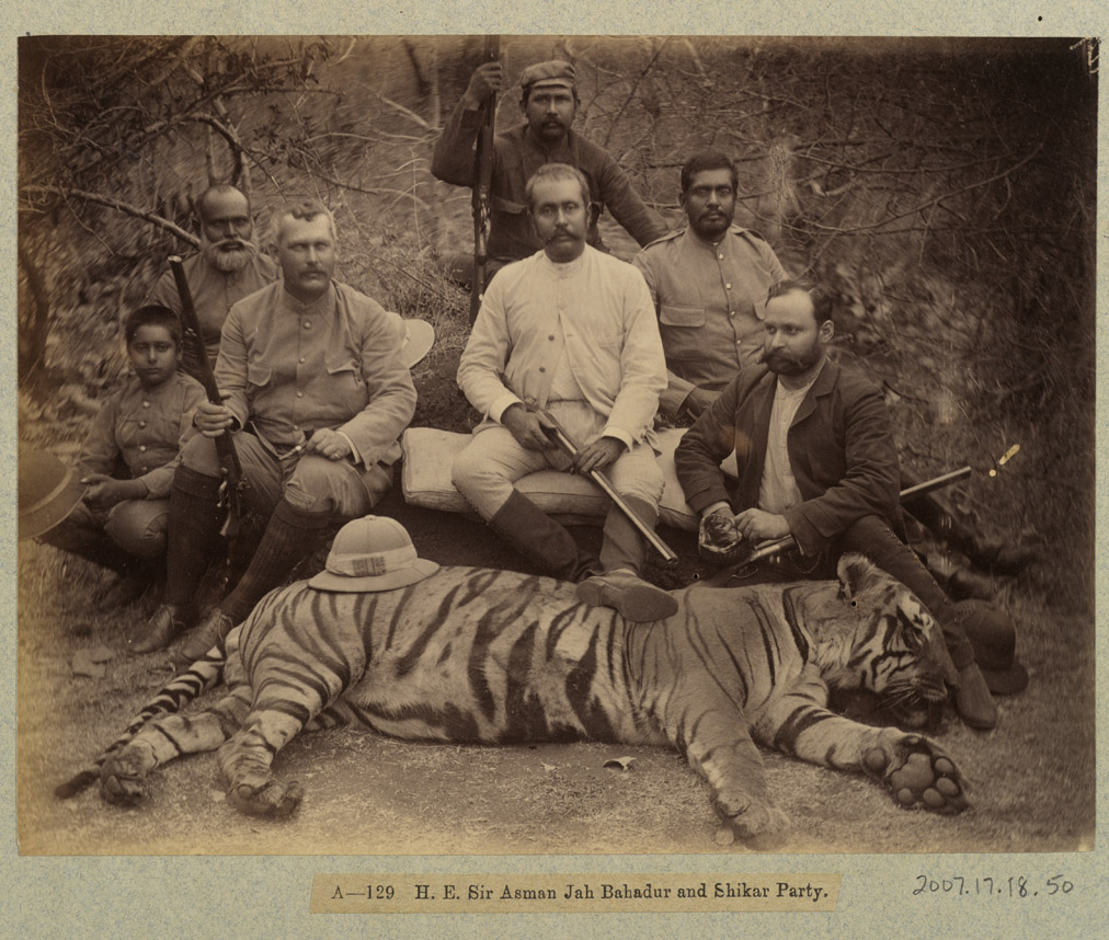 Photo of men posing with hunting equipment